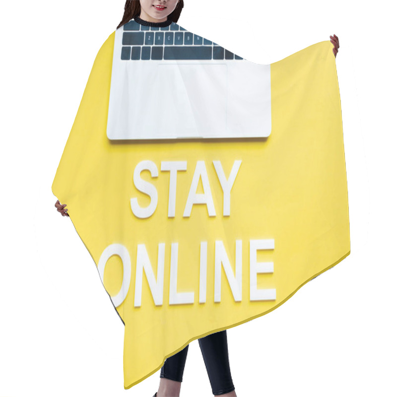 Personality  Top view of stay online lettering and laptop on yellow surface hair cutting cape