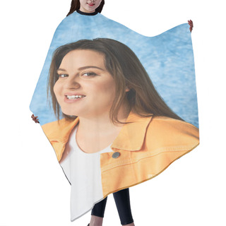 Personality  Portrait Of Positive Plus Size Woman With Long Hair And Natural Makeup Wearing Crop Top And Orange Jacket While Posing And Looking At Camera On Mottled Blue Background, Body Positive  Hair Cutting Cape