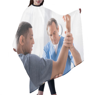 Personality  Therapist Working With Injured African American Man On Blurred Foreground In Clinic  Hair Cutting Cape