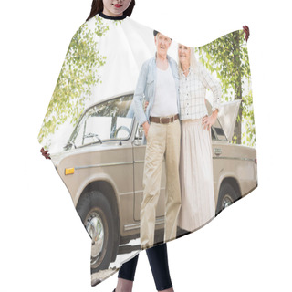Personality  Bottom View Of Senior Couple Standing Near Beige Vintage Car And Looking At Camera  Hair Cutting Cape