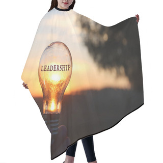 Personality  Hand Holding Light Bulb With The Text Leadership In Front Of The Bright Sun Hair Cutting Cape