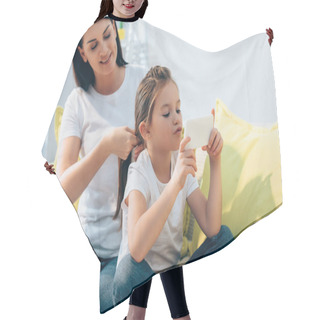 Personality  Smiling Mother Plaiting Hair Of Daughter With Smartphone On Blurred Background Hair Cutting Cape