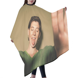 Personality  Funny Model With Closed Eyes And Outstretched Hands Sticking Out Tongue On Green Background Hair Cutting Cape