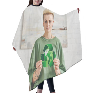 Personality  Positive Tattooed Woman With Trendy Hairstyle Showing Green Recycling Sign With Globe While Smiling At Camera In Modern Living Room, Sustainable Living And Environmental Awareness Concept Hair Cutting Cape