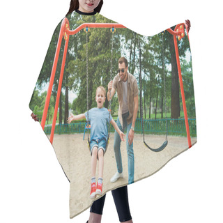 Personality  Father And Son Having Fun On Swing At Playground In Park Hair Cutting Cape
