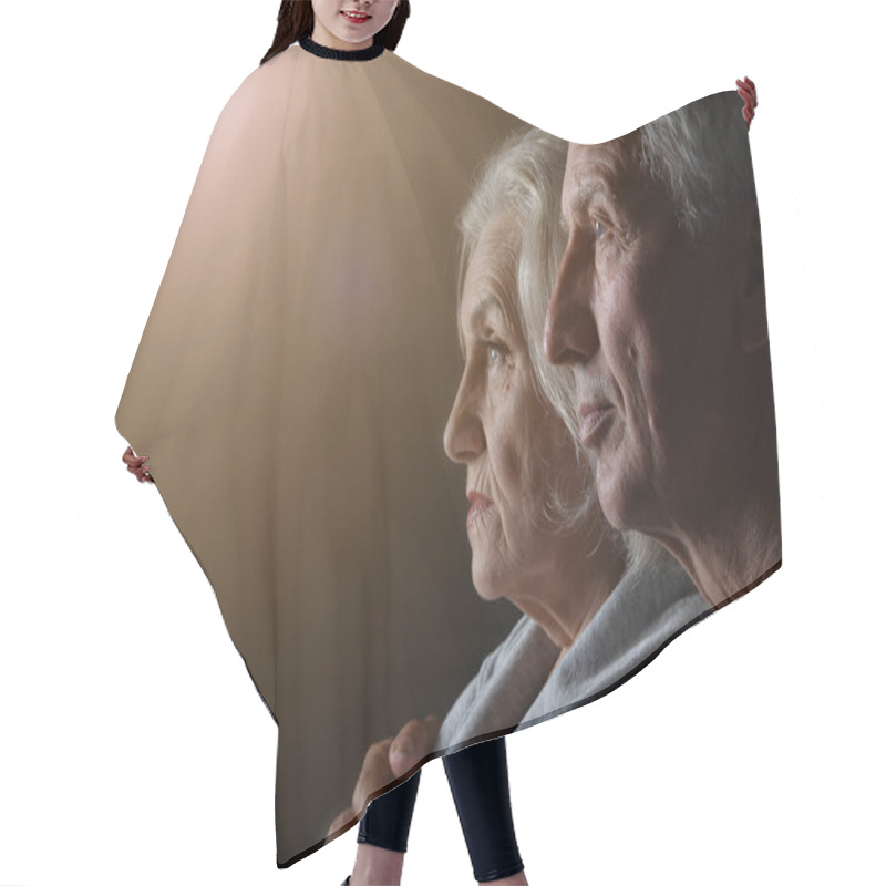Personality  Portrait Of Sad Senior Couple Posing At Home  Hair Cutting Cape