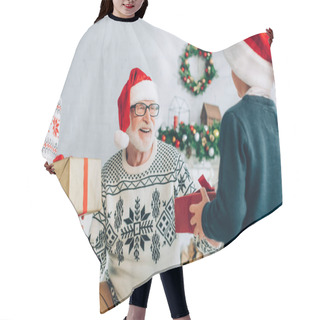 Personality  Happy Senior Man In Santa Hat Taking Christmas Gifts From Grandchildren Hair Cutting Cape