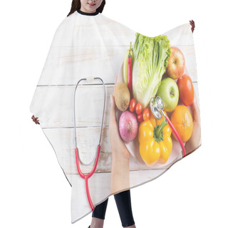 Personality  Healthy Lifestyle, Food And Nutrition Concept. Close Up Doctor Woman Hand Holding Plate Of Fresh Vegetables And Fruits With Stethoscope Lying On White Wooden Table. Hair Cutting Cape