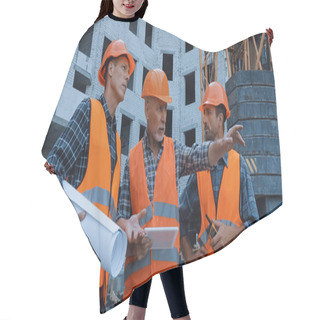Personality  Mature Worker Pointing With Hand And Talking Near Coworkers And Building Crane On Construction Site Hair Cutting Cape