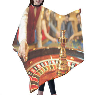 Personality  The Croupier Holds A Roulette Ball In A Casino In His Hand. Hair Cutting Cape