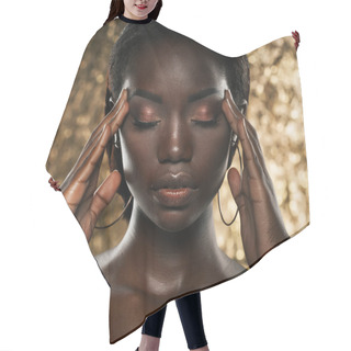 Personality  Fashion Studio Portrait Of An Extraordinary Beautiful African American Model With Closed Eyes  Over Golden Background Hair Cutting Cape