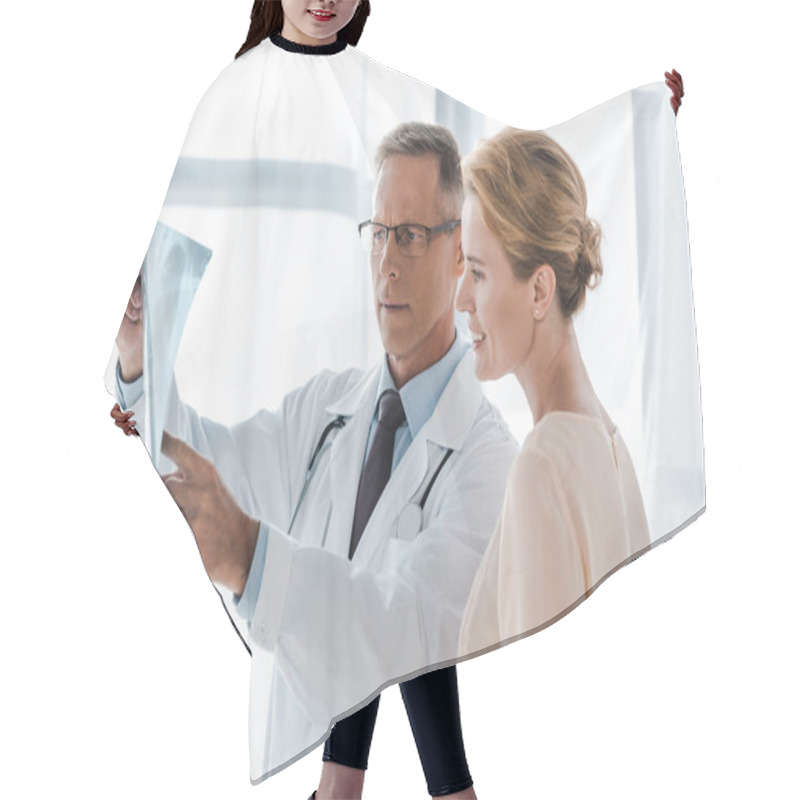 Personality  Doctor In White Coat Pointing With Finger At X-ray Near Positive Woman In Clinic  Hair Cutting Cape