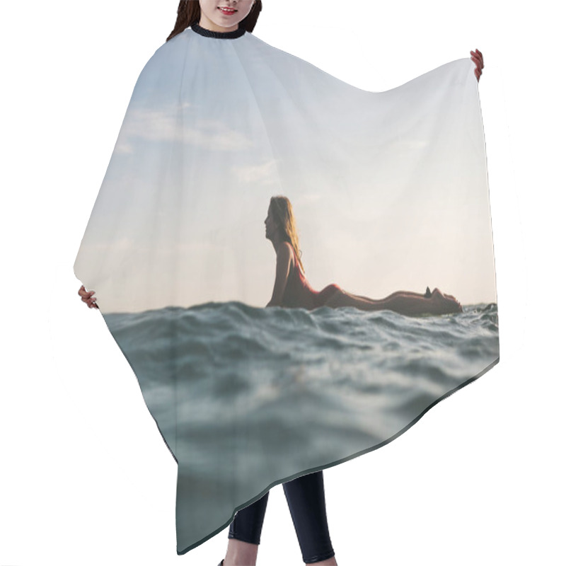 Personality  Side View Of Woman In Swimming Suit Surfing Alone In Ocean Hair Cutting Cape