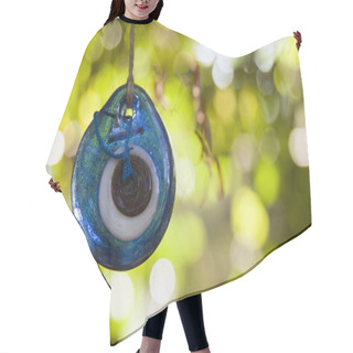 Personality  Blue Amulet Hanging On A Tree. Hair Cutting Cape