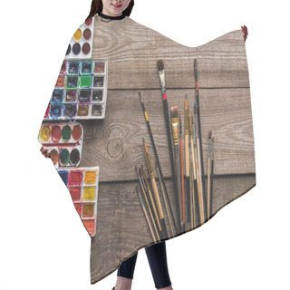 Personality  Top View Of Colorful Paint Palettes On Wooden Brown Surface With Paintbrushes Hair Cutting Cape