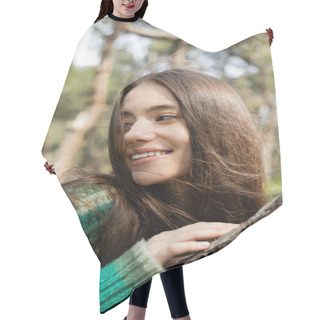 Personality  Portrait Of Smiling Young Woman In Sweater Touching Tree In Blurred Park  Hair Cutting Cape
