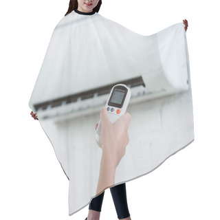 Personality  Cropped Shot Of Woman Pointing At Air Conditioner Hanging On Brick Wall With Remote Control Hair Cutting Cape