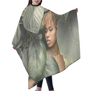 Personality  Young And Modern African American Woman With Makeup Touching And Looking At Green Foliage While Standing In Greenhouse, Stylish Woman Enjoying Lush Tropical Surroundings Hair Cutting Cape