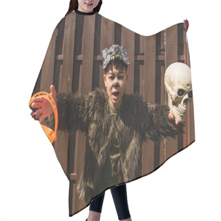 Personality  Astonished Asian Boy In Werewolf Costume Running With Skull And Halloween Bucket On Backyard Hair Cutting Cape