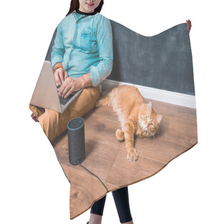 Personality  Work From Home With Funny Lazy Red Cat Pet. Man Sitting On Laminate Wooden Floor With Laptop Computer And Smart Speaker Alexa. Ginger Pet Cat Lying. Home Office. Remote Work Hair Cutting Cape
