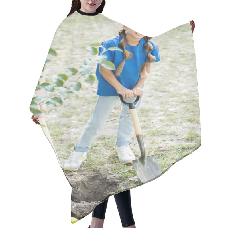 Personality  Girl Looking At Camera While Holding Shovel Near Mother And Young Green Tree, Ecology Concept Hair Cutting Cape