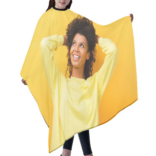 Personality  Happy African American Woman Looking Away While Fixing Curly Hair On Yellow Hair Cutting Cape
