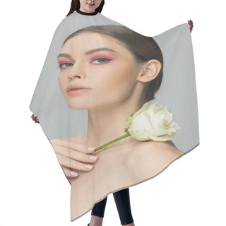 Personality  Sensual Woman With Pink Makeup Holding Fresh Rose Near Naked Shoulder And Looking At Camera Isolated On Grey Hair Cutting Cape