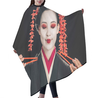 Personality  Smiling Beautiful Geisha In Black Kimono With Red Flowers In Hair And Closed Eyes Holding Chopsticks Isolated On Black Hair Cutting Cape