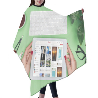 Personality  Cropped Image Of Female Architect Holding Digital Tablet With Pinterest On Screen At Table With Divider, Coffee And Potted Plant  Hair Cutting Cape