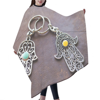 Personality  Two Key Rings In The Form Of Fatima Hand On A Brown Leather Background. Ancient Symbol And Traditional Modern Tourist Souvenir Of Tunisia Hair Cutting Cape