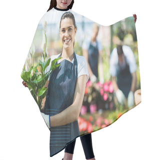 Personality  Happy Female Nursery Owner With Pot Of Flowers Inside Greenhouse Hair Cutting Cape