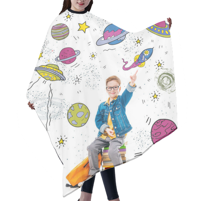 Personality  smiling schoolboy pointing up while sitting on pile of books with backpack, isolated on white with fantasy universe, planets and spaceships hair cutting cape
