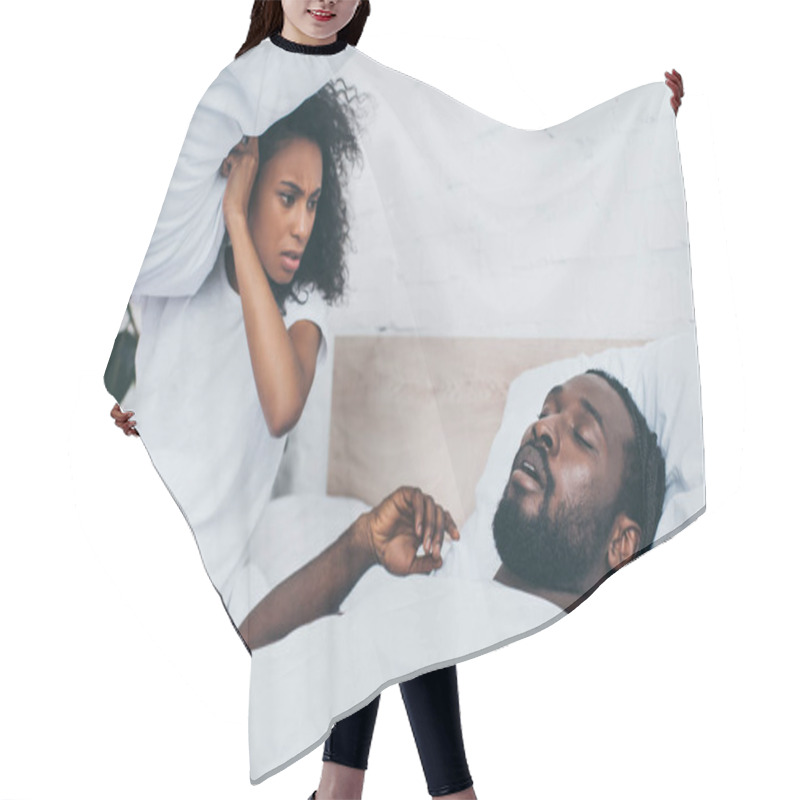 Personality  Angry African American Woman Holding Pillow While Sitting In Bed Near Snoring Husband Hair Cutting Cape