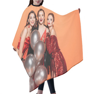 Personality  Laughing Beautiful Girls In Stylish Party Clothes Holding Bundle Of Grey Balloons And Looking At Camera Isolated On Orange Hair Cutting Cape