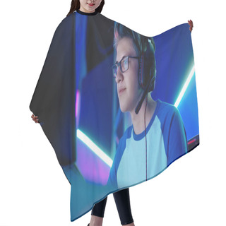 Personality  Teenage Boy Gamer Plays In Competitive Video Game On A ESports Tournament/ Internet Cafe. He Wears Glasses And Headphones With Microphone. Hair Cutting Cape