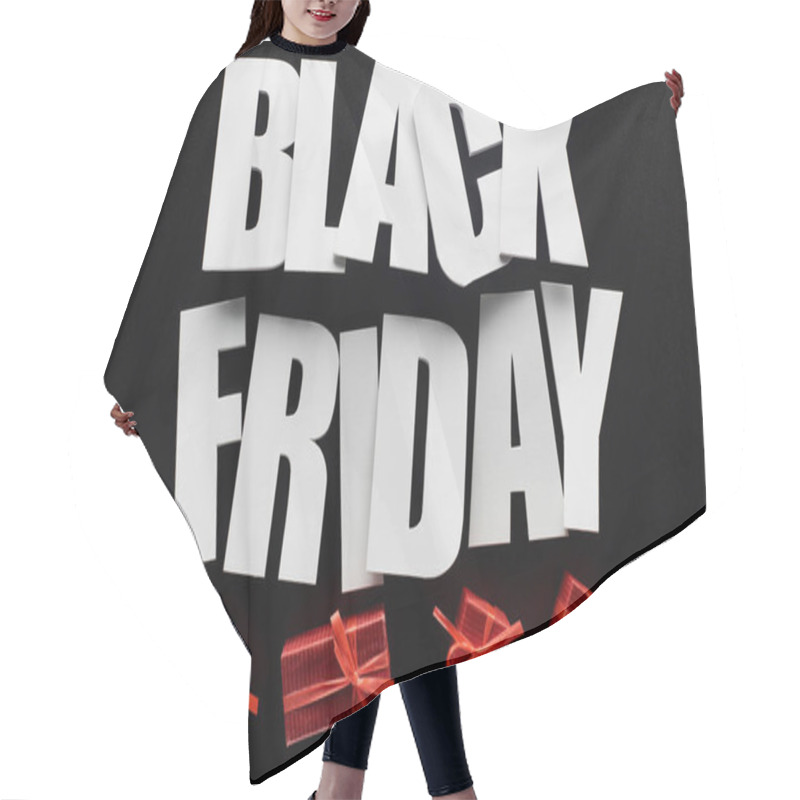 Personality  top view of black Friday lettering and red presents isolated on black hair cutting cape