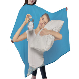 Personality  Displeased Young Woman Holding  Vintage Alarm Clock And Lying On Pillow On Blue Background, Morning Hair Cutting Cape