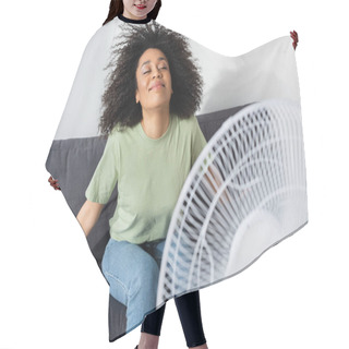 Personality  Joyful African American Woman Sitting On Couch Near Blurred Electric Fan Hair Cutting Cape