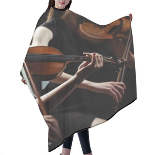 Personality  Partial View Of Two Female Professional Musicians Playing On Violins On Dark Stage  Hair Cutting Cape
