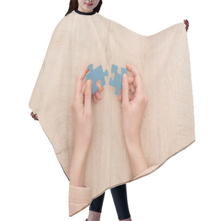 Personality  Cropped View Of Female Hands Holding Blue Puzzles On Wooden Table Hair Cutting Cape