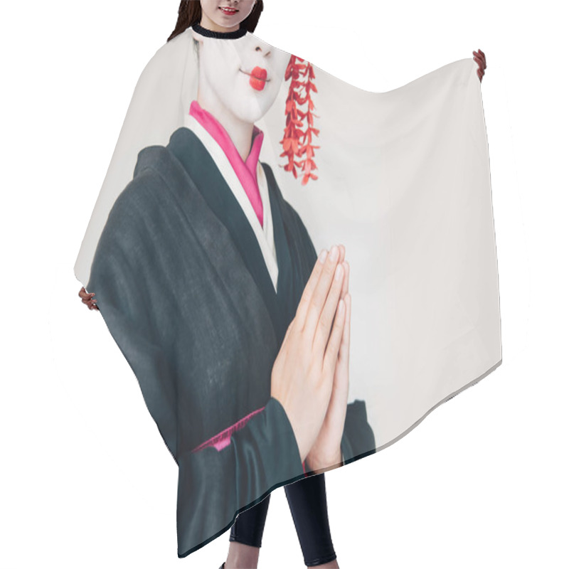 Personality  cropped view of smiling beautiful geisha in black kimono with greeting hands isolated on white hair cutting cape