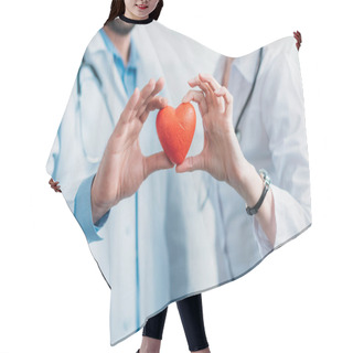 Personality  Cropped Shot Of Doctors Holding Toy Heart Together Hair Cutting Cape