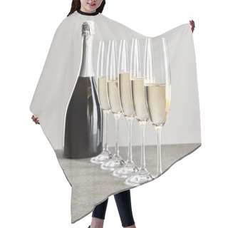 Personality  Selective Focus Of Champagne Glasses With Sparkling Wine Near Bottle Isolated On Grey  Hair Cutting Cape