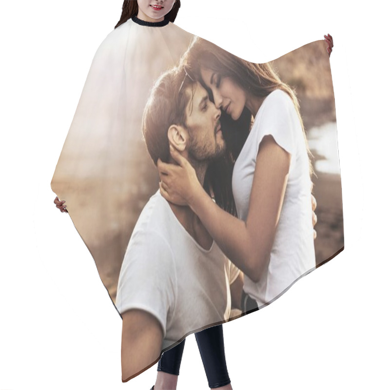 Personality  Handsome man hugging his sensual girlfriend hair cutting cape