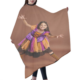 Personality  Spooky Girl In Halloween Witch Costume Growling And Gesturing On Brown Backdrop, Full Length Hair Cutting Cape