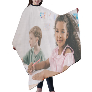 Personality  Selective Focus Of Multicultural Preschoolers At Table With Papers And Pencils In Classroom Hair Cutting Cape
