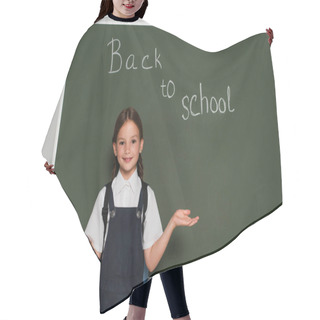Personality  Cheerful Schoolgirl Pointing With Hands Near Chalkboard With Back To School Lettering On Grey Hair Cutting Cape