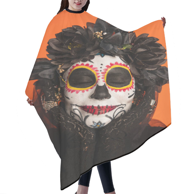 Personality  portrait of smiling woman with closed eyes and creepy halloween makeup holding hands near face isolated on orange hair cutting cape