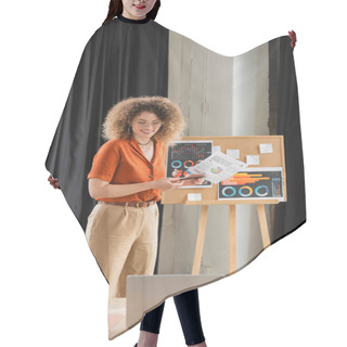 Personality  Happy Businesswoman In Glasses Holding Infographics Near Office Board During Video Call  Hair Cutting Cape