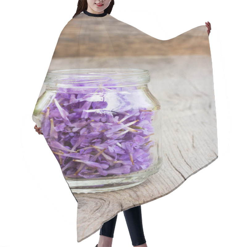 Personality  pale lilac flower petals in a glass jar on old wooden boards in the cracks. the concept of aromatherapy, alternative medicine hair cutting cape
